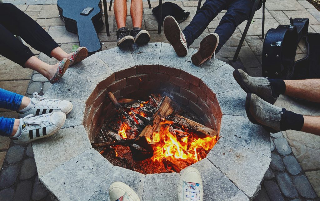 Outdoor stone fire pit with patio seating for Summit County hardscape and outdoor fireplace construction